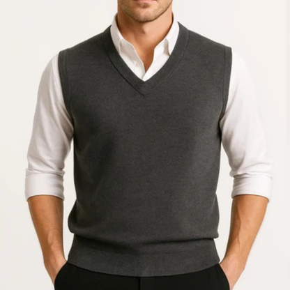 Men's sleeveless V-neck sweater vest layered over a collared shirt