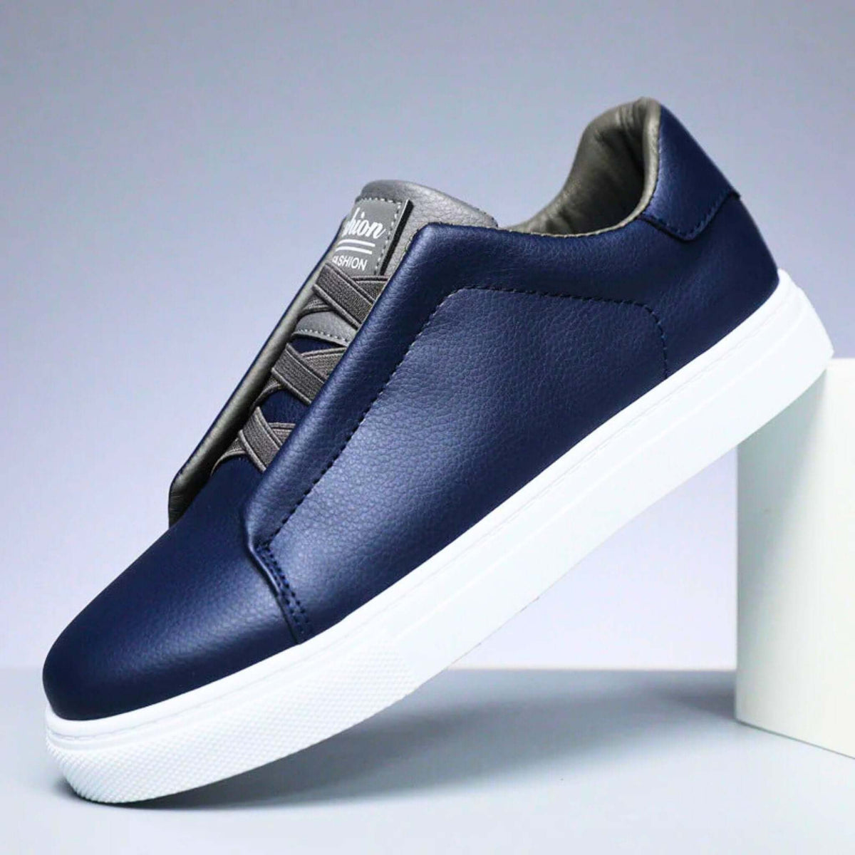 Low-top lace-up sneaker with contrast panelled upper and flat sole