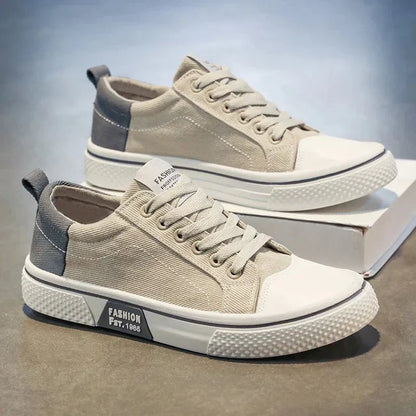 Low top lace-up trainers with panelled uppers, round toes and contrast soles