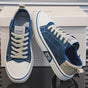 Low top lace-up trainers with panelled uppers, round toes and contrast soles