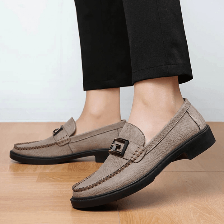 Textured slip-on loafers with geometric front trim and stitched toe detailing