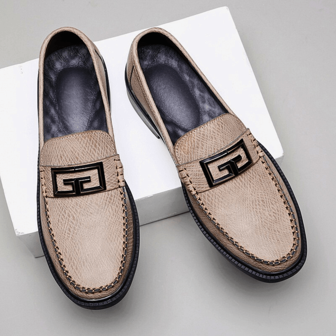 Textured slip-on loafers with geometric front trim and stitched toe detailing