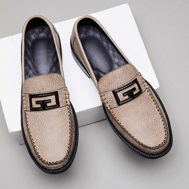 Textured slip-on loafers with geometric front trim and stitched toe detailing