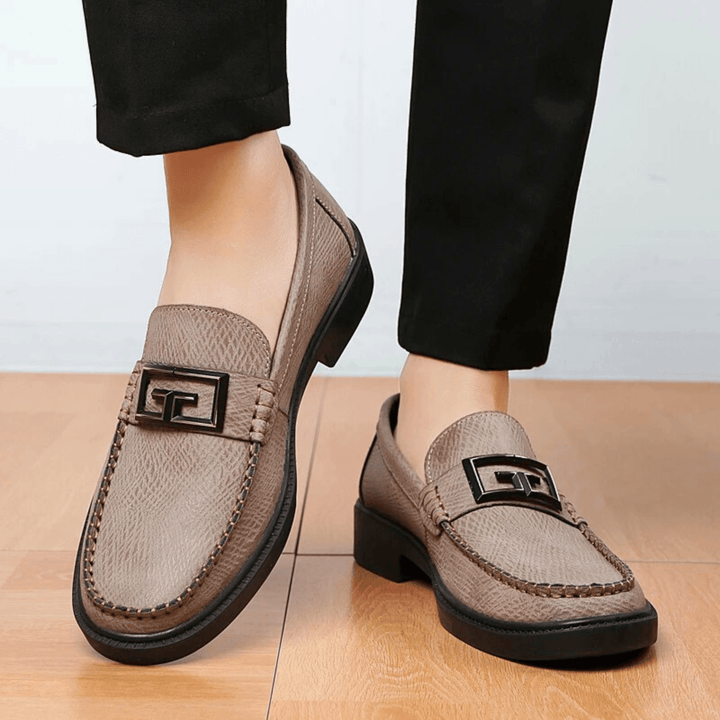 Textured slip-on loafers with geometric front trim and stitched toe detailing
