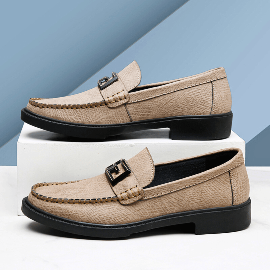 Textured slip-on loafers with geometric front trim and stitched toe detailing