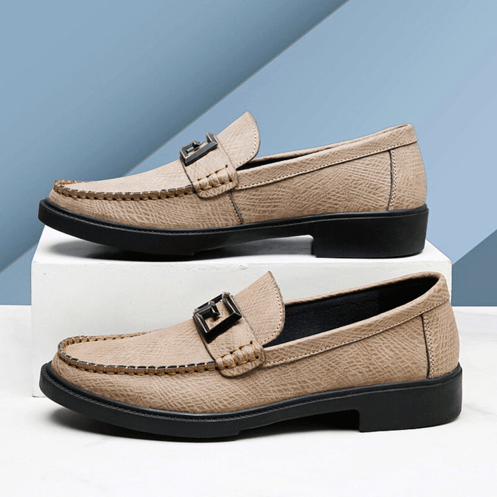 Textured slip-on loafers with geometric front trim and stitched toe detailing