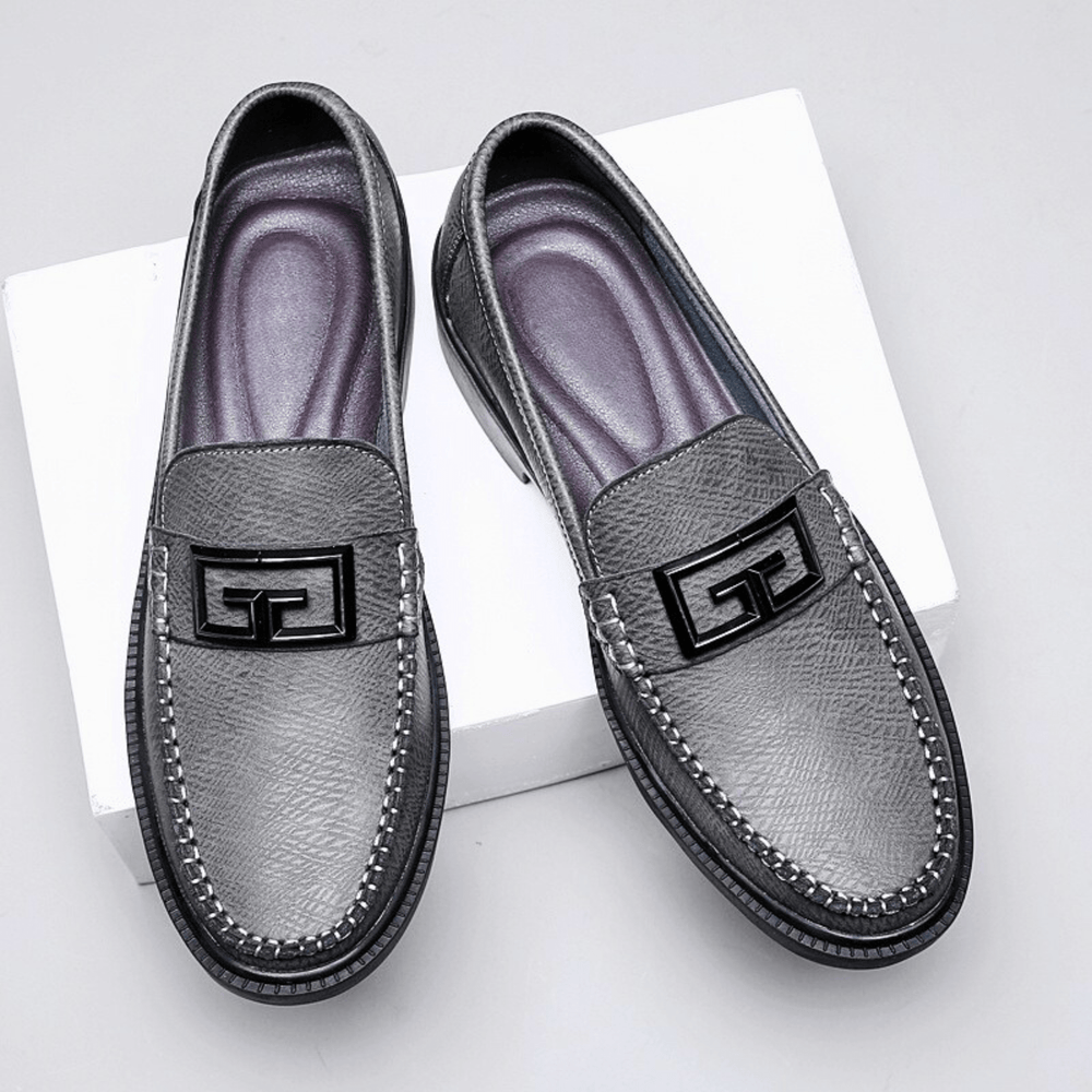 Textured slip-on loafers with geometric front trim and stitched toe detailing