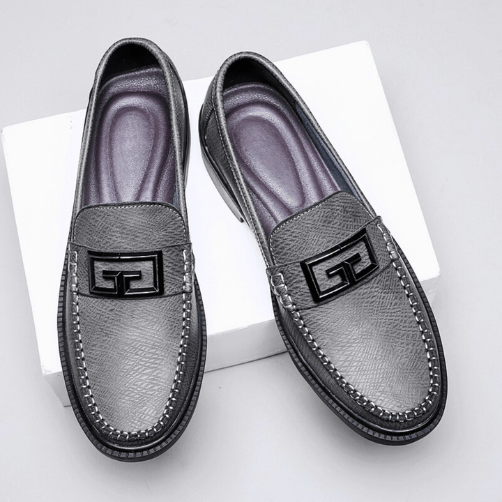 Textured slip-on loafers with geometric front trim and stitched toe detailing