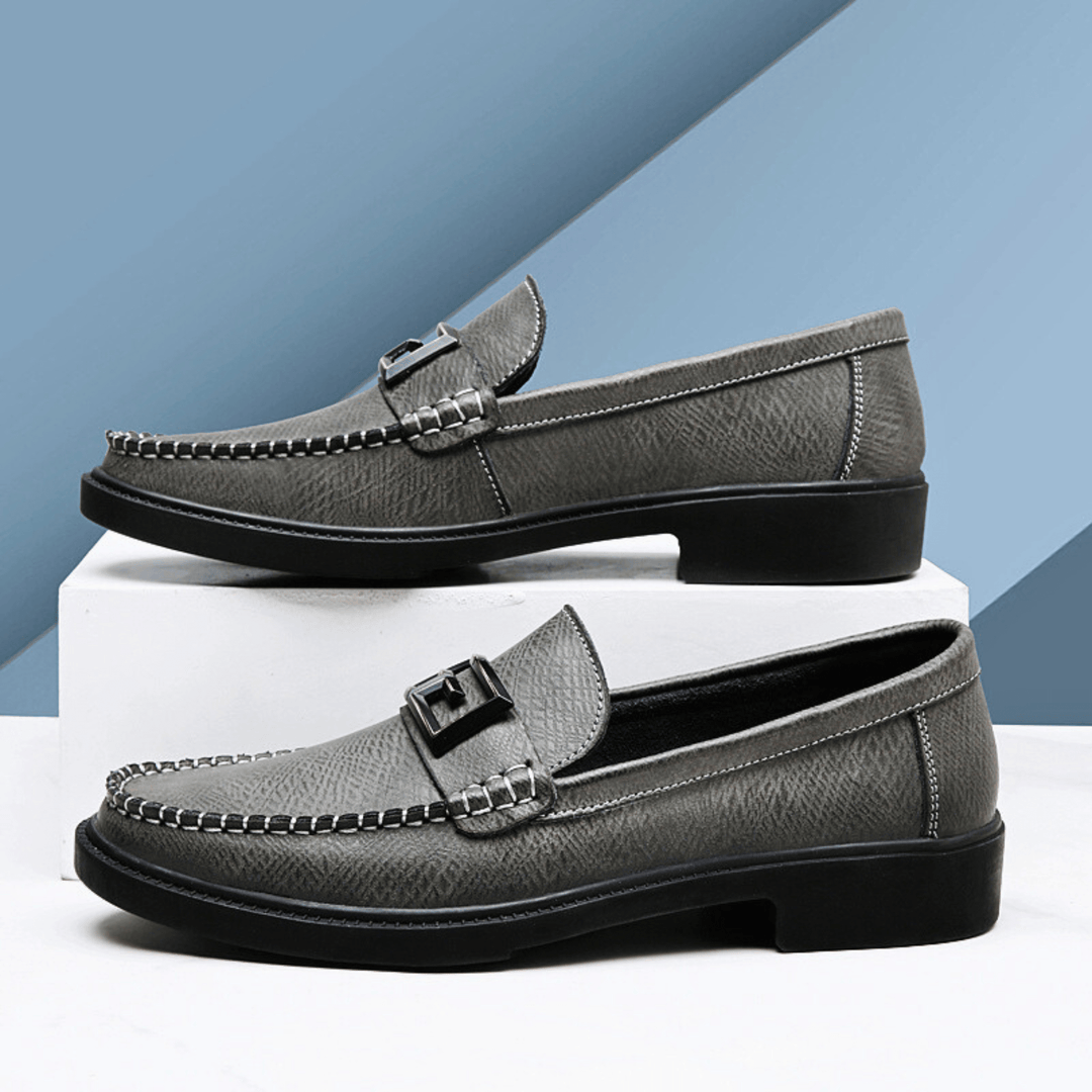 Textured slip-on loafers with geometric front trim and stitched toe detailing