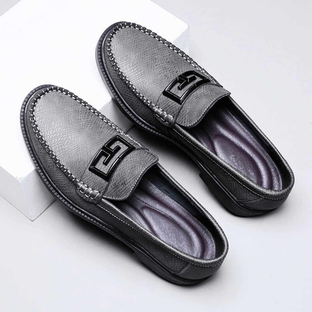 Textured slip-on loafers with geometric front trim and stitched toe detailing