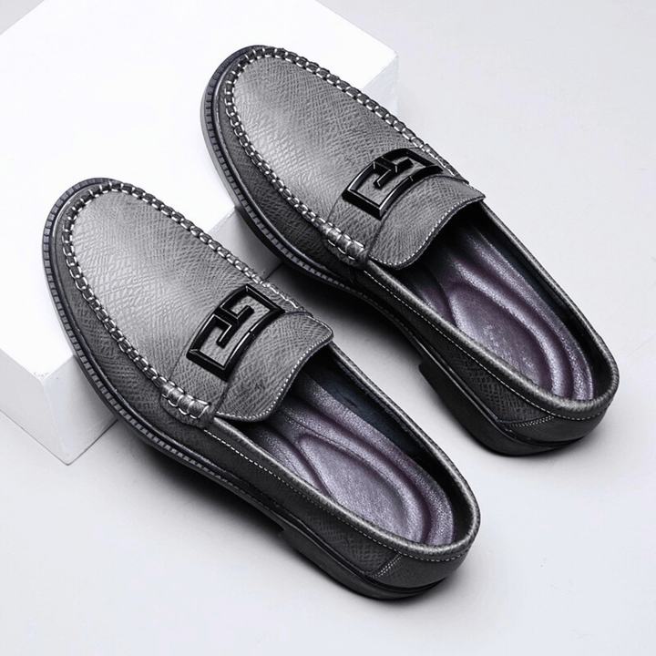 Textured slip-on loafers with geometric front trim and stitched toe detailing