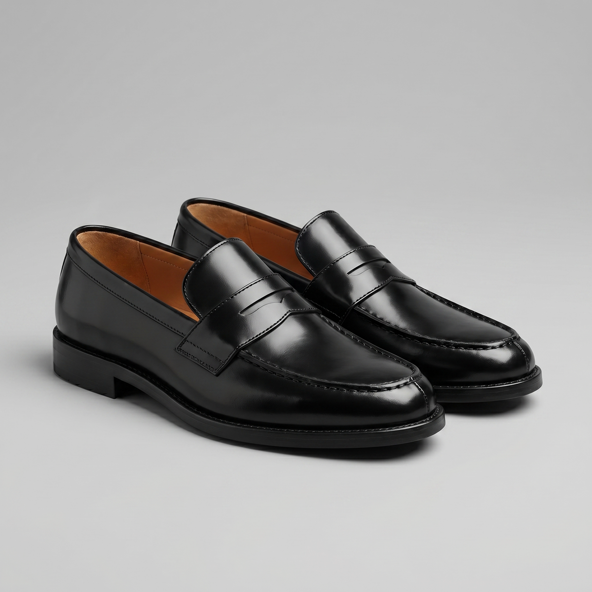 Men's black penny loafers with round toes and low block heels