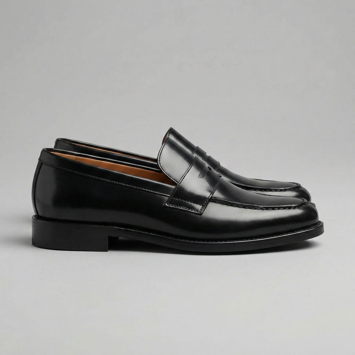 Men's black penny loafers with round toes and low block heels