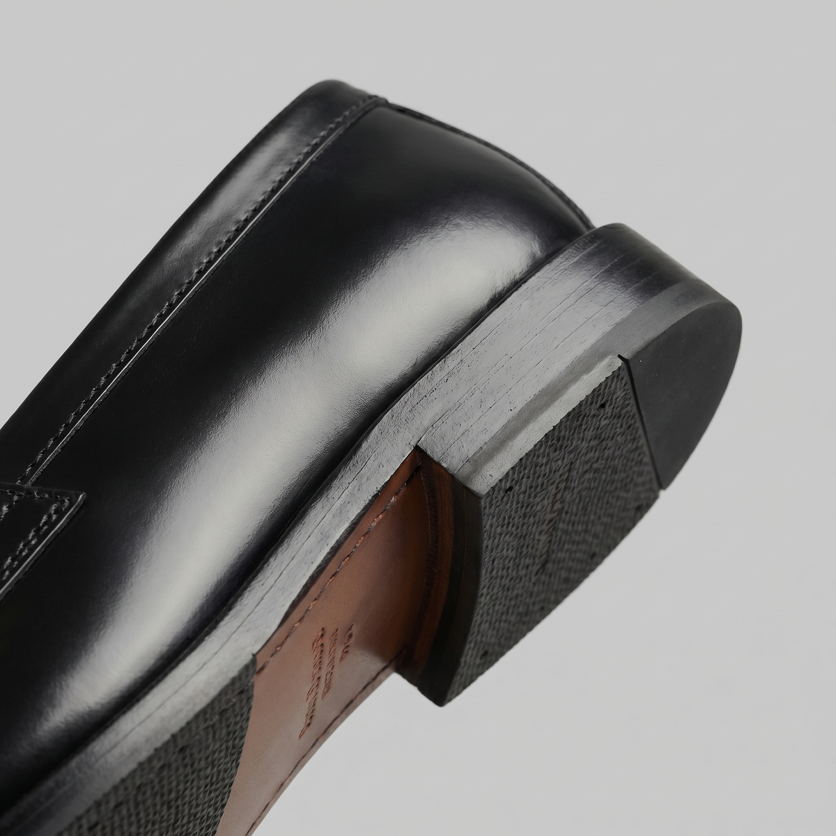 Men's black penny loafers with round toes and low block heels