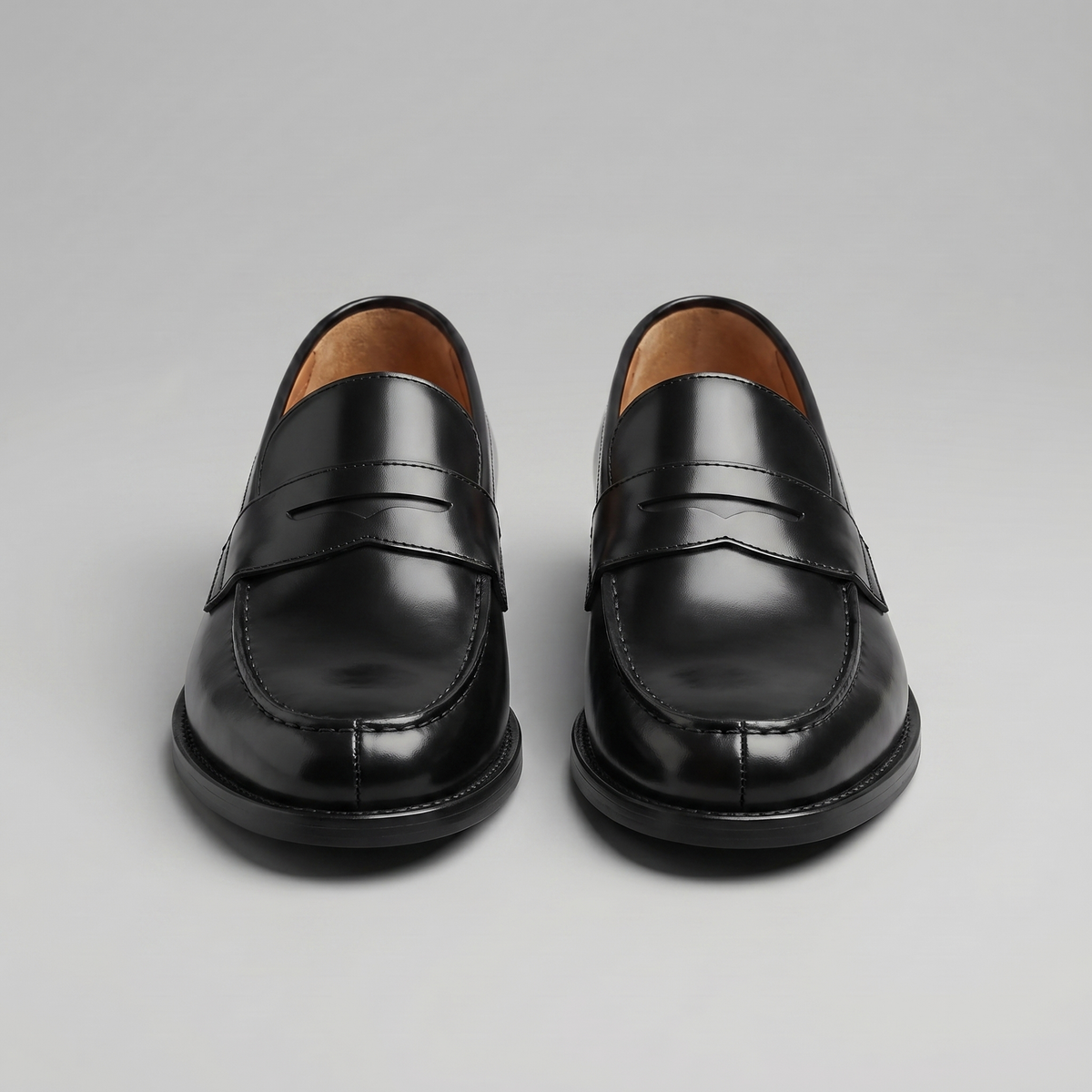 Men's black penny loafers with round toes and low block heels