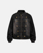 Napoleon-style washed denim jacket with mandarin collar and buttoned front tabs