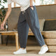 Men's tapered ankle pants with drawstring waist in cream, displayed with white sneakers