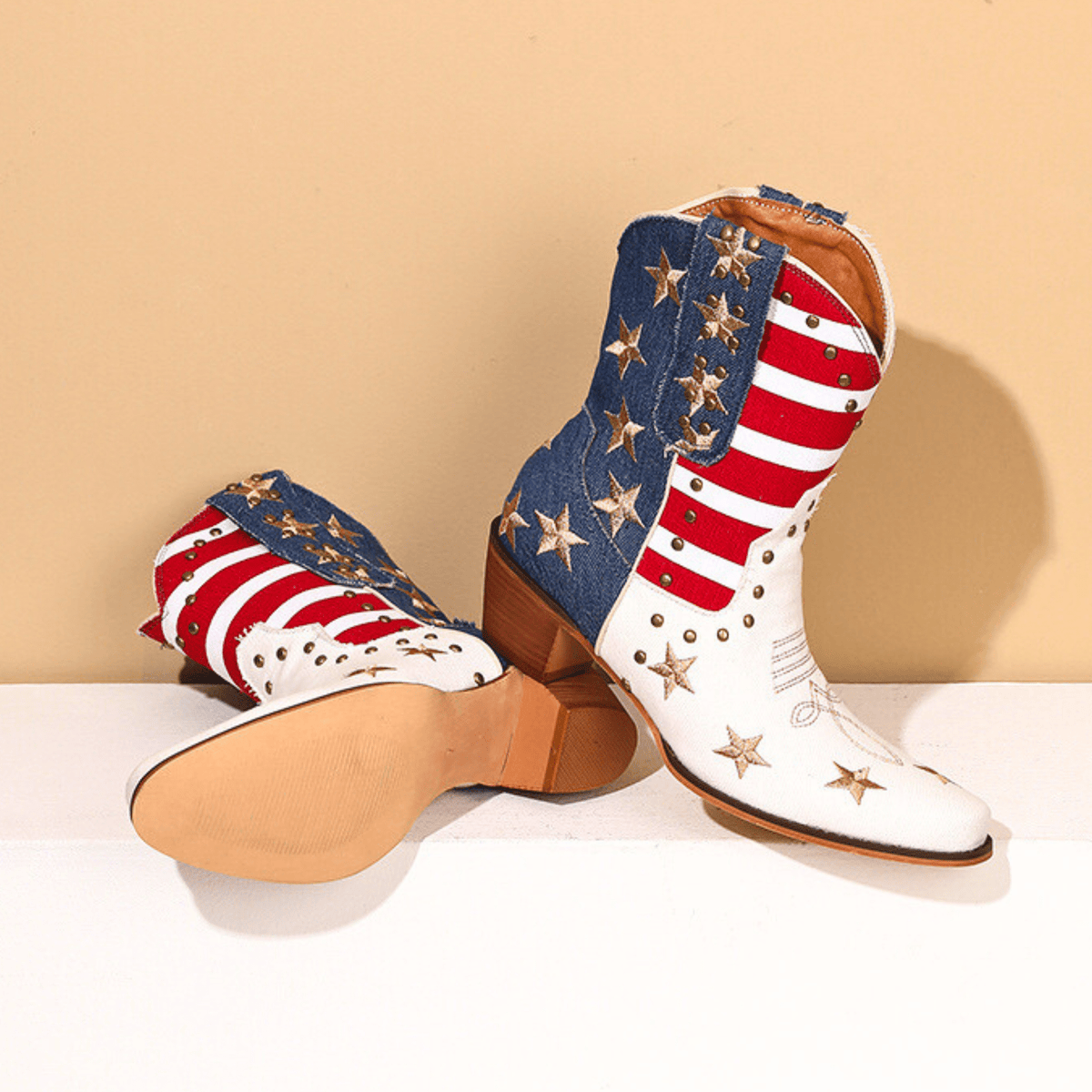 Ivory-white cowboy boots with red striped shafts, blue star panels and brown block heels