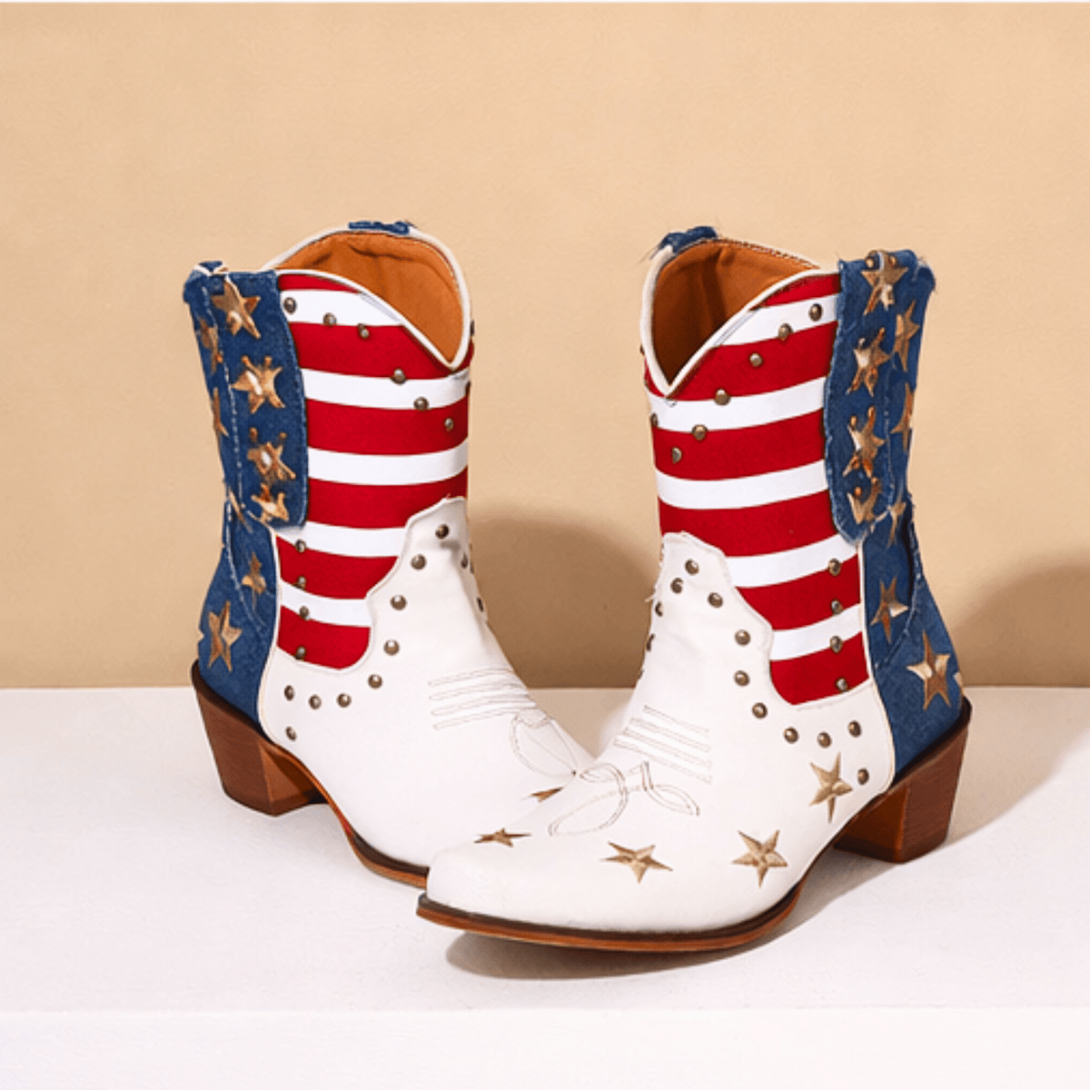 Ivory-white cowboy boots with red striped shafts, blue star panels and brown block heels